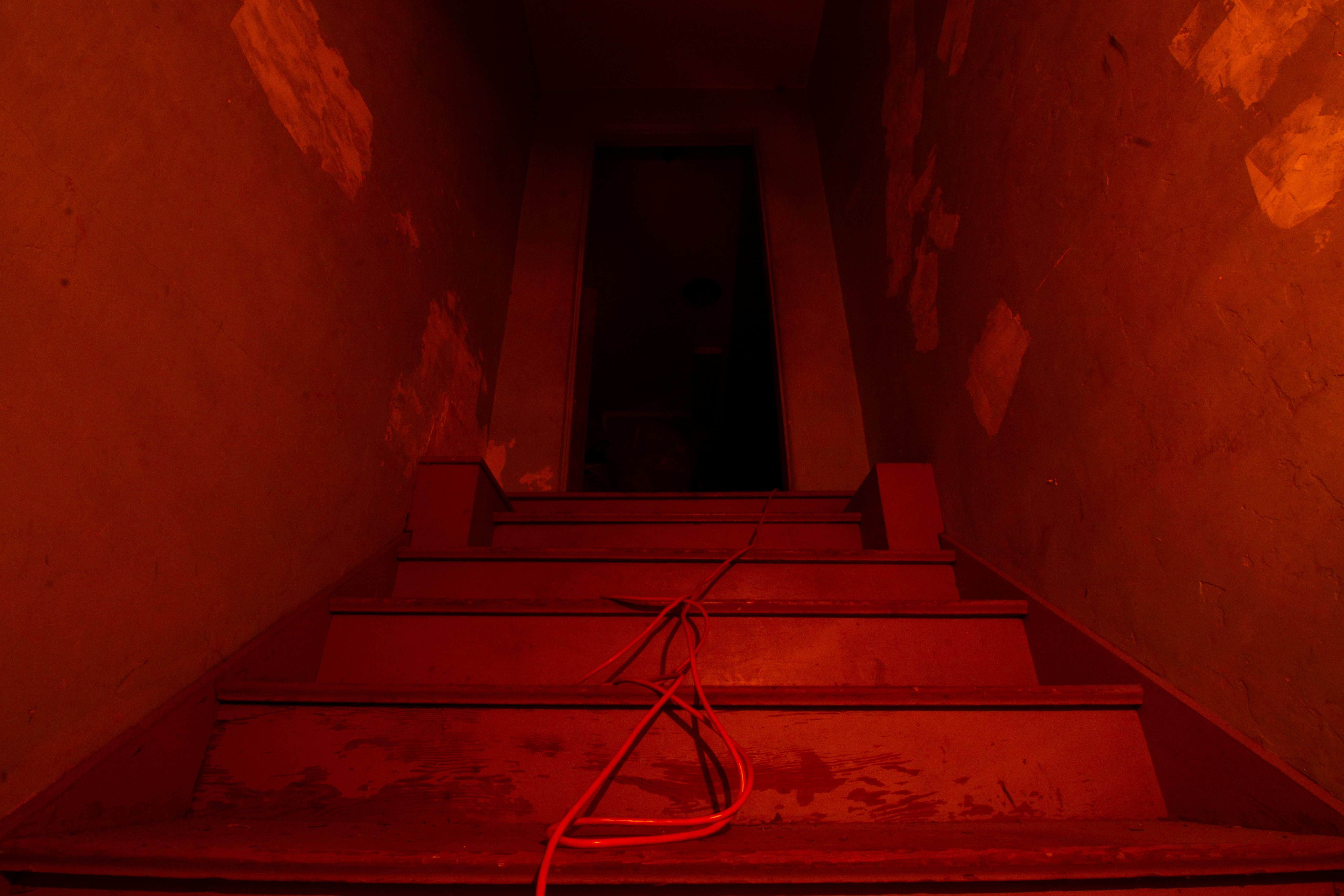 A staircase bathed in dim red light.